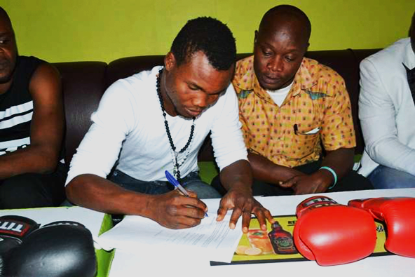  George Ashie signing the deal with Reinsport Management 